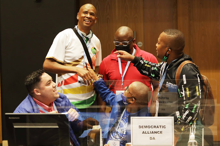 ANC, Patriotic Alliance and Democratic Alliance supporters in conversation at the Provincial Results & Operations Centre in Century City, Cape Town.