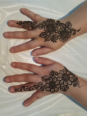 Freshly applied henna on hands.