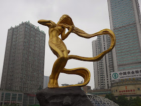 The Liuyang River (浏阳河) statue — a woman playing a violin but without a bow — at Furong Square