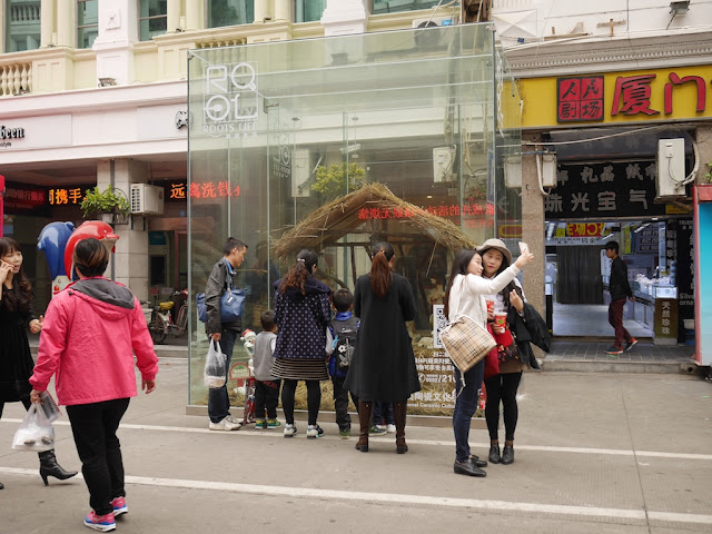 two young females taking a selfie in front of a nativity scene with Olaf at the Zhongshan Road Pedestrian Street in Xiamen