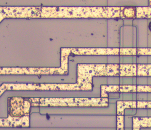 A pinch resistor inside the 555 timer. The resistor is a strip of P silicon between two metal contacts. An N layer on top pinches the resistor and increases the resistance.