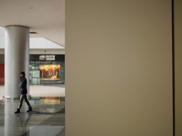 hidden, barely visible Apple logo on a wall outside the Xiamen Apple Store