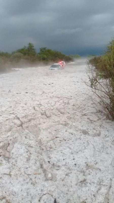 Cars drive through the debris of a hailstorm in Argentina that dumped almost five feet of hailstones in minutes, 28 October 2017. Photo: SMN Argentina