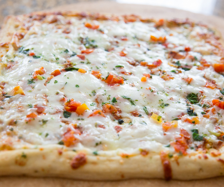 close-up photo of an unsliced pizza