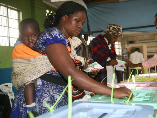 A woman casts her vote at the Pumwani Social Hall on March 04, 2013 /HEZRON NJOROGE