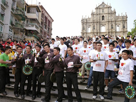 several young men proudly lifting their bottles of beer