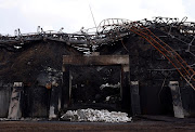 Piles of burnt sunflower seed meal is pictured at a destroyed area of the Nika-Tera grain terminal, as Russia's attacks on Ukraine continue, in Mykolaiv, Ukraine June 12, 2022.