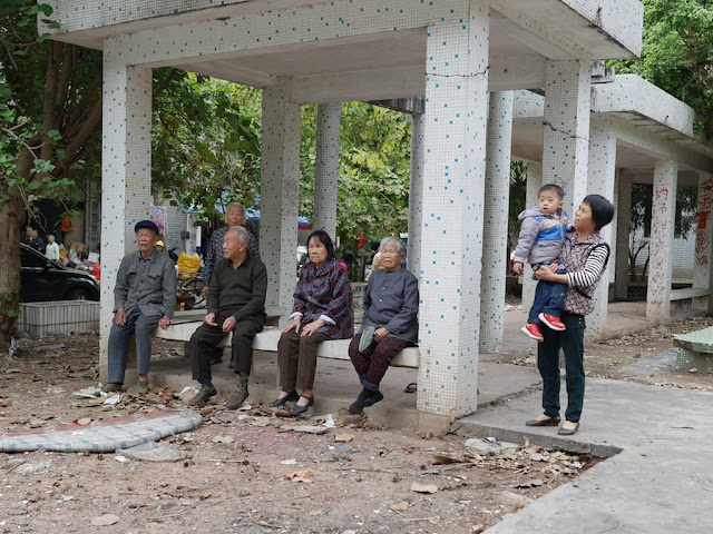 people watching a Gods Parade in Maoming, China