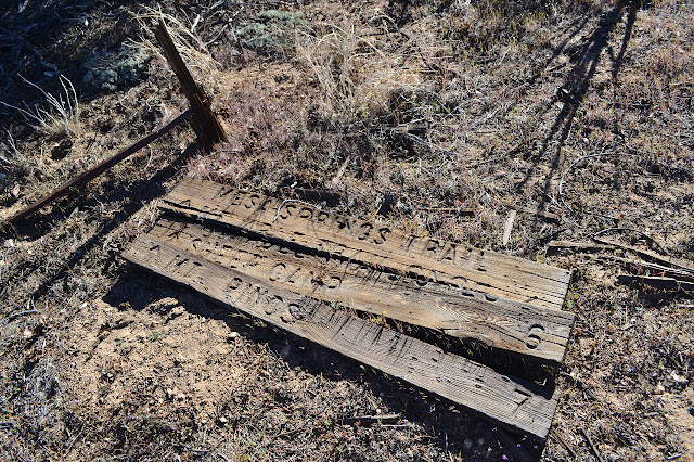 split wooden sign on the ground