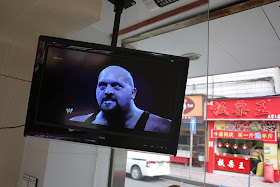 U.S. professional wrester on a TV screen in Changsha, China.