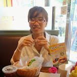 fumie enjoying Freshness burger and my FAN underneath my plate which caused a mess in Shinagawa, Japan 