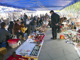 various sellers at an outdoor antique market in Changsha, China