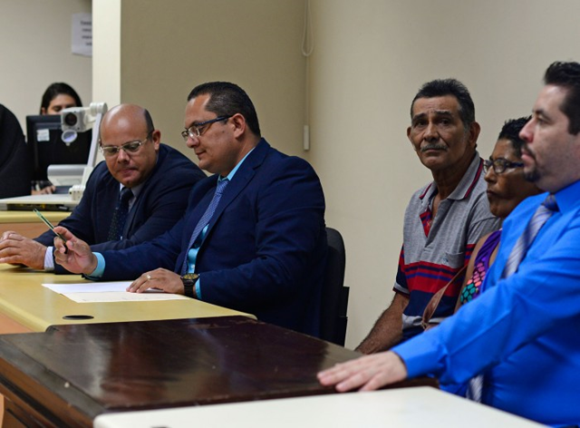 Surrounded by prosecutors, Rafael Mora, center, the father of slain environmentalist Jairo Mora, awaits a verdict in his son's murder trial on Tuesday, 29 March 2016. Photo: Lindsay Fendt / The Tico Times