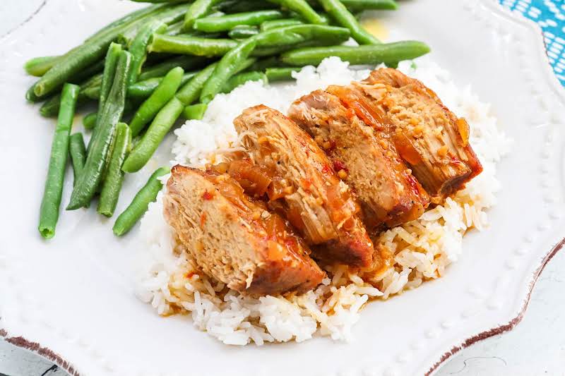 Sliced Sweet & Spicy Pork Tenderloin On A Plate.