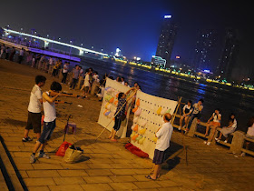 two people shooting balloons at night in Hengyang, China