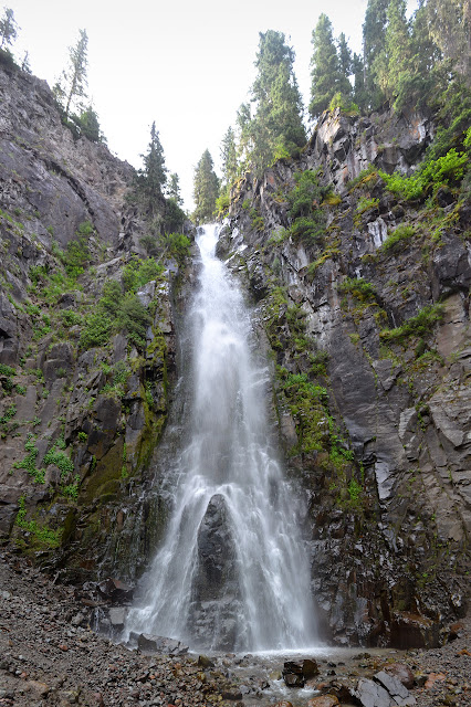 in the spray of the waterfall