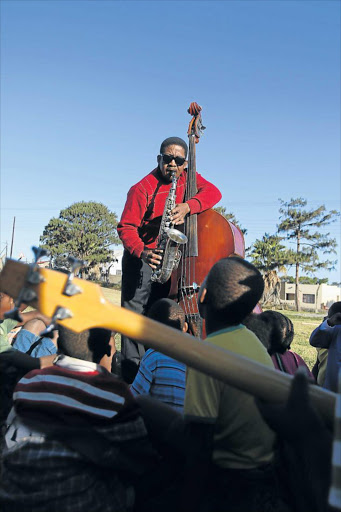 CHANGING LIVES: Jazz legend and bass player Lulama Gawulana teaches music to enthusiasts at Masizakhe Children’s Home at NU2 in Mdantsane Picture: MICHAEL PINYANA