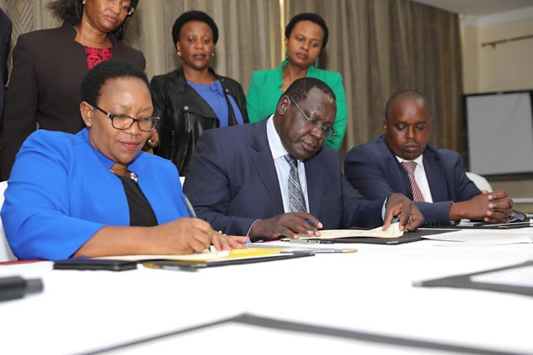 Outgoing Health CS Sicily Kariuki, Kiambu Deputy Governor James Nyoro and Elgeyo Marakwet Governor Alex Tolgos during the signing of the UHC agreement on January 15, 2020. Looking on are Kiambu health officials