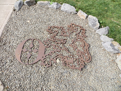 Ommegang Logo as part of the landscaping at Ommegang Brewery in Cooperstown, New York