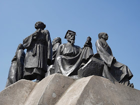 statues of scholars on a large rock in Shigu Park, Hengyang