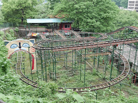 metal roller coaster with track going through a giant cats mouth