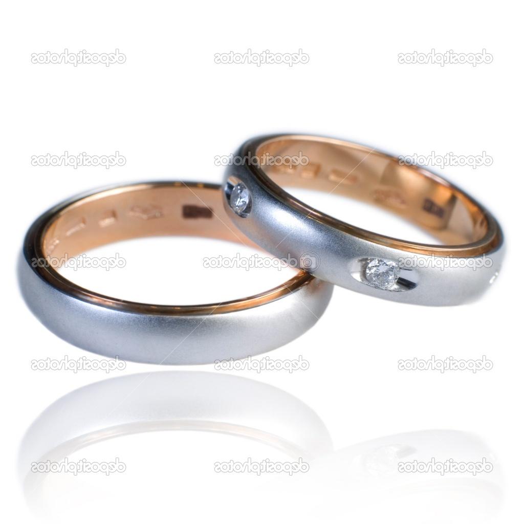 His and hers golden wedding bands, with diamonds. On a white background with