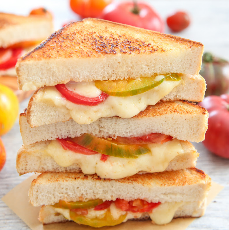 close-up photo of a stack of grilled cheese and tomato sandwiches