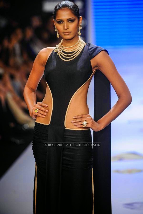 A model showcases a creation for designer Farah Khan on Day 1 of India International Jewellery Week (IIJW), 2014 at Grand Hyatt, Mumbai.