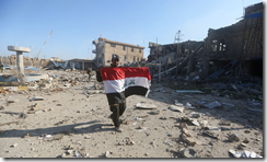 RAMADI.a member of iraqi security forces holds the national flag on Dec. 28 after the recapure of the city