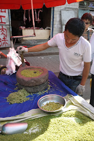 man grinding and selling fresh qingke in Xining, China