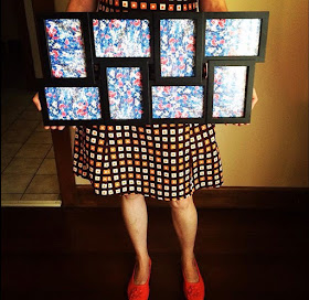 Camille holding a conjoined photo frame filled with blue floral print 