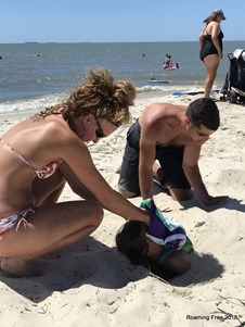 Trying to keep sand out of her face!