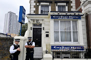 Police officers stand outside the City Stay Hotel used by Alexander Petrov and Ruslan Boshirov; who have been accused of attempting to murder former Russian spy Sergei Skripal and his daughter Yulia; in London, on September 5 2018.
