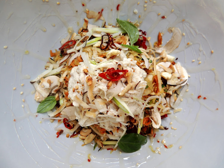 Poached lemongrass and coconut chicken on satay noodle salad with Thai basil and crispy chilli