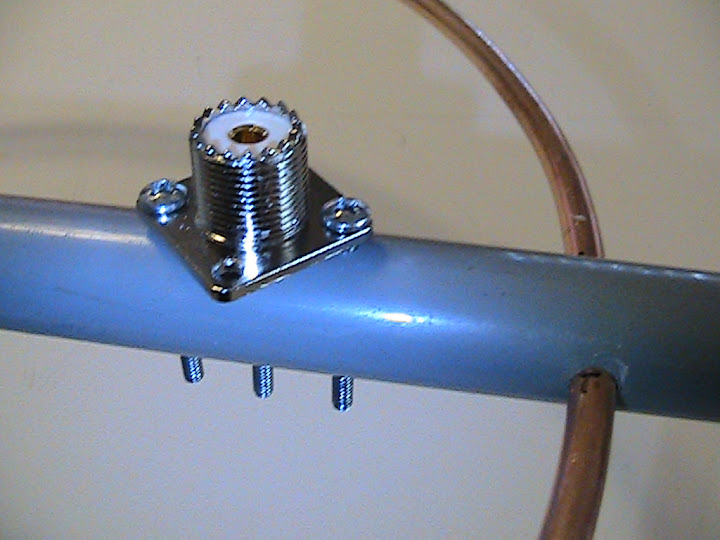 The
                      SO-239 antenna connector is secured to the PVC
                      boom with two 6-32 x 1" screws.