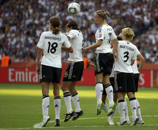 Kerstin Garefrekes, Annike Krahn, Alexandra Popp and Saskia Bartusiak of Germany (L to R) miss to block a free kick during their Women's World Cup group A match in Berlin June 26, 2011