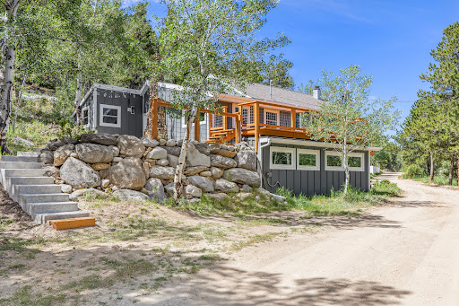 House with stone stairs and deck in this luxury house for sale in Nederland ($865,000)