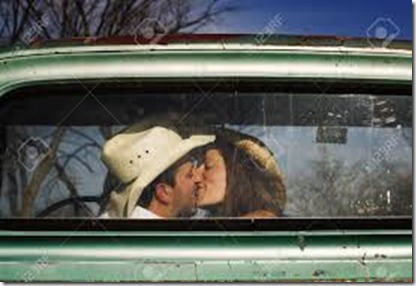 4404633-Cowboy-and-girlfriend-kissing-in-through-the-back-window-of-a-pickup-truck-Stock-Photo