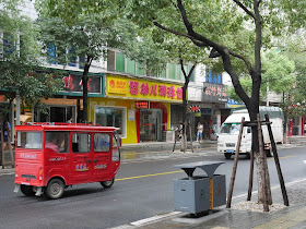 a red auto-rickshaw on a street