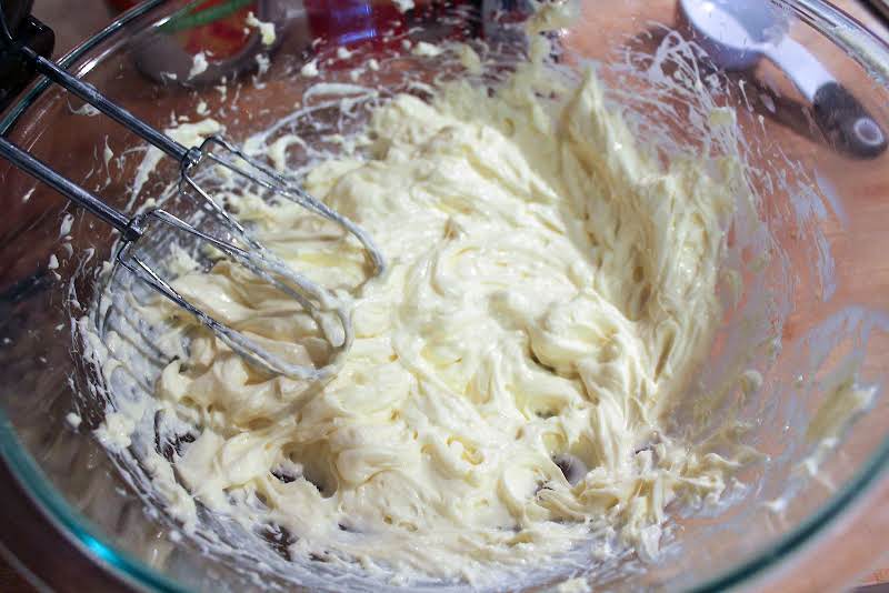 Cream Cheese, Sugar, Egg, And Vanilla Extract Whipped Together In A Bowl.