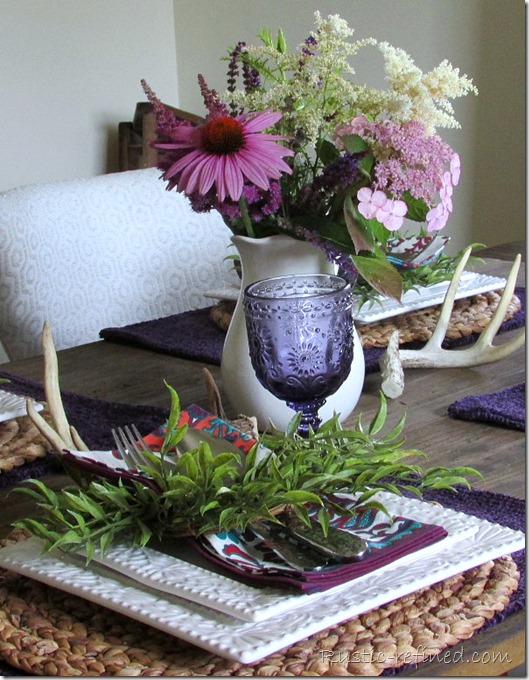 Setting a rustic tablescape on a Restoration Hardware Flat Iron Dining Table. Using Antlers, fresh flowers and white dishes for Summer.