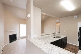 Stone bar top in the kitchen overlooking the carpeted living area