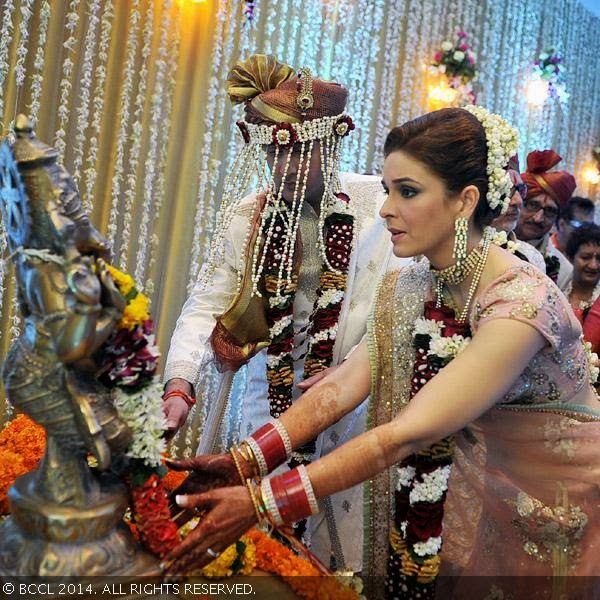 Wedding couple, Raageshwari Loomba and Sudhanshu Swaroop take blessings from Lord Ganesha during their wedding, held in Mumbai, on January 27, 2014.