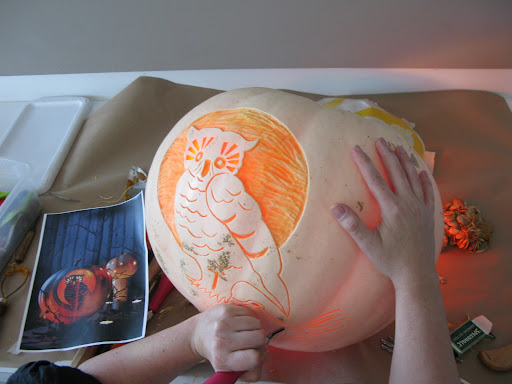 Marcie illuminates the pumpkin from within, to see how the carving is going.