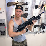 holding a SAW M249 machine gun at lock & load Miami in Miami, United States 