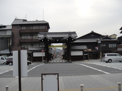 Old-looking gate beckoning towards small streets