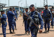 Congolese policemen guard the border crossing point with Rwanda after a Congolese soldier was killed in a clash near an area where the Congolese army is fighting M23 rebels, following renewed tensions around Goma in the North Kivu province, Democratic Republic of Congo on June 17, 2022. 