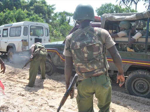 Security officers keep guard at along the Lamu Kiunga road within the Boni forest./ALPHONCE GARI