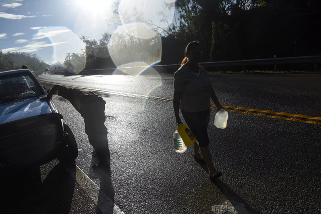 Drivers stop for water at a spring in Utuado, Puerto Rico, in September 2017. The island had water problems even before Hurricane Maria. Photo: Michael Robinson Chavez / The Washington Post