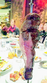 Fogo de Chao meat is carved tableside until you can't take it anymore, all you can eat!